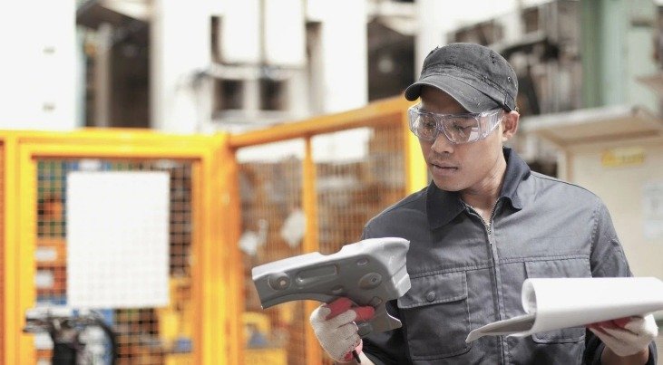 A person checking product codes against a provided list.