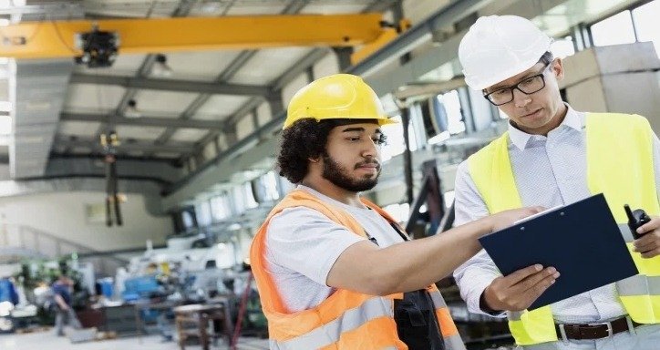 An image showing two people checking a list in a warehouse.