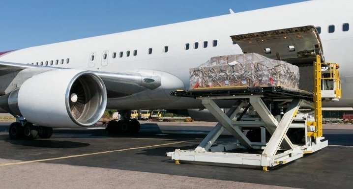 An image showing cargo being loaded onto an airplane.