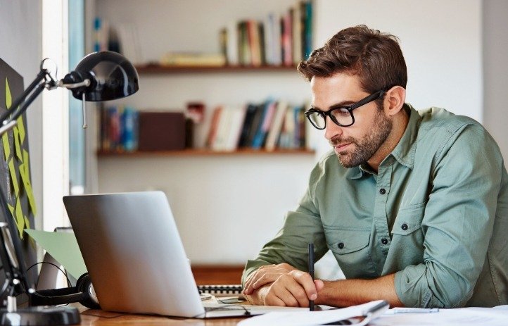 A person focused on their work using a laptop.
