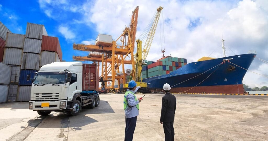 Two people checking shipments on a large cargo ship.