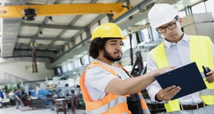 Two people discussing in a warehouse.