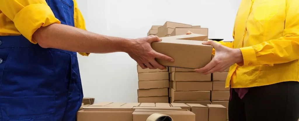 one person is handling a parcel to another