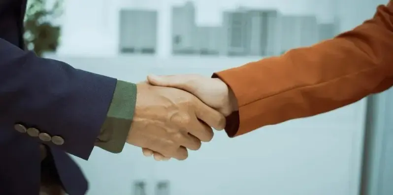 two persons are shaking hands