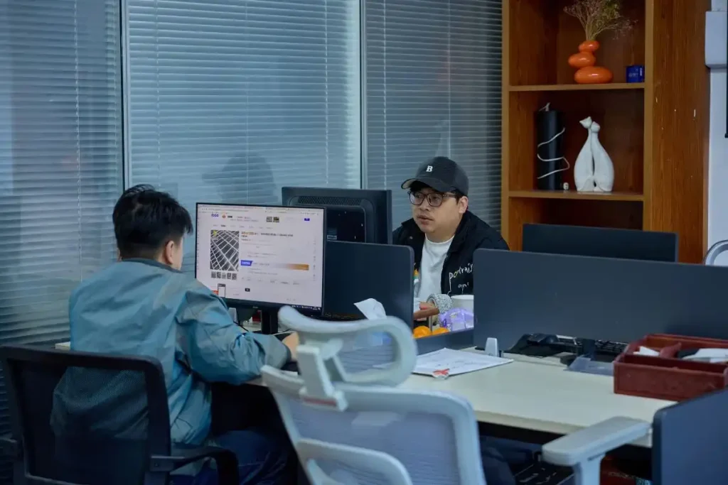 Change Sourcing team members working in an office, reviewing supplier information and sourcing plans to help South African importers source correctly from China.